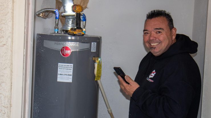 Tony member inspecting hot water heater at Arizona residence